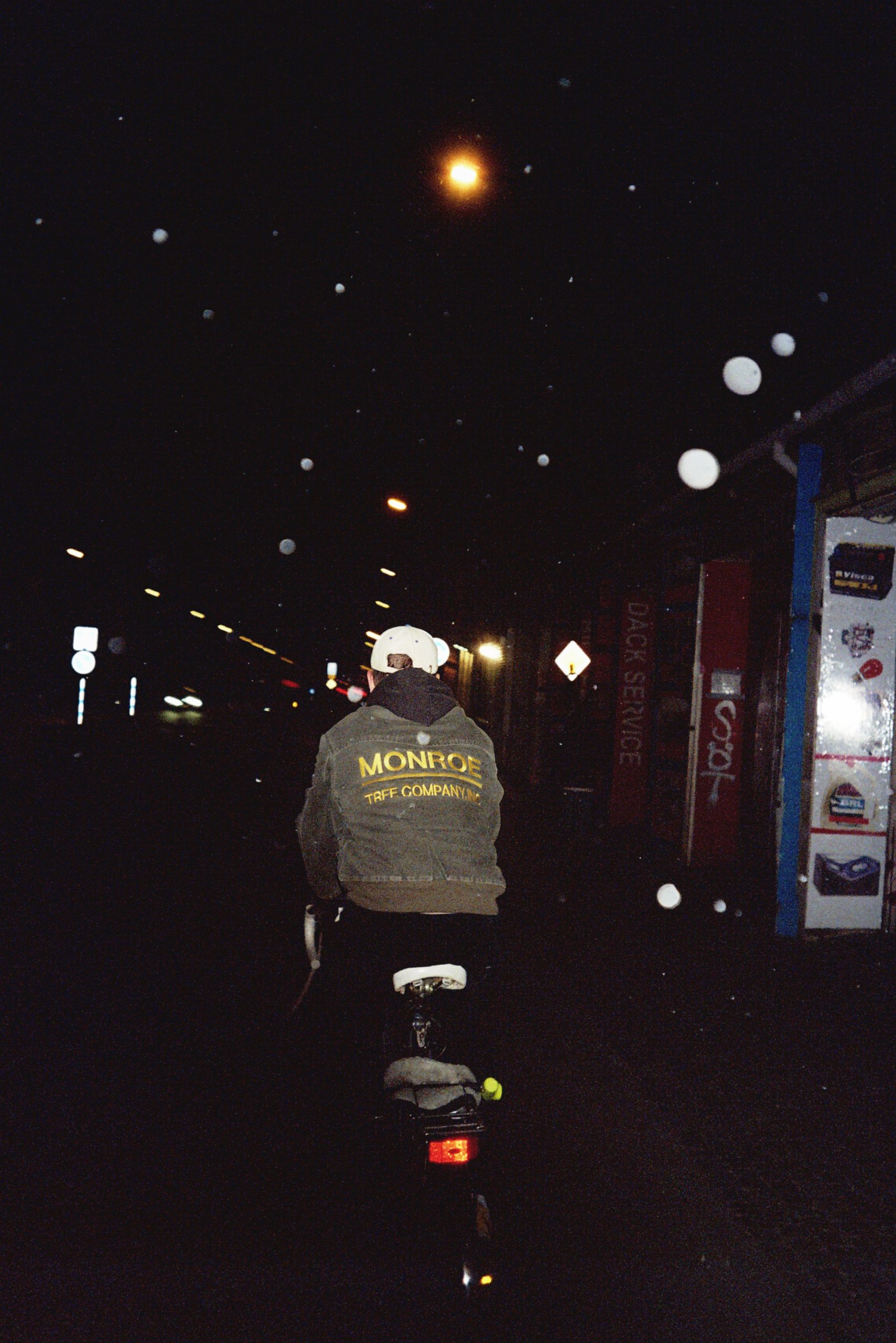 Analog photography on a boy on a bike in nightfall