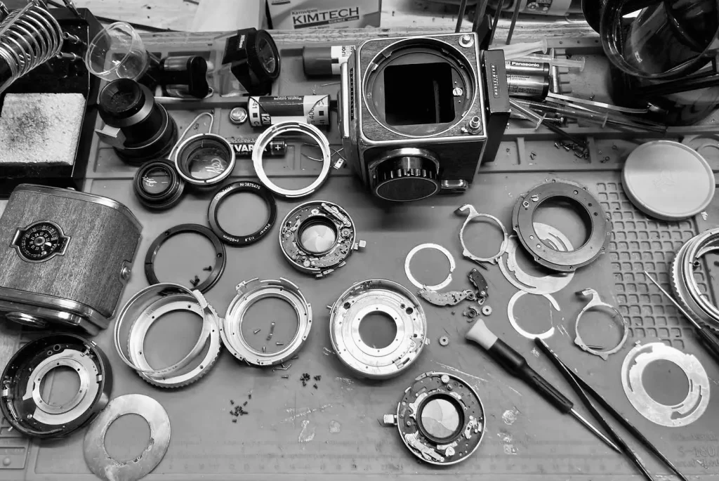 Camera parts on a table photo in black and white